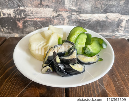 Traditional Japanese pickled vegetables: pickled eggplant, cucumber, and daikon radish. Traditional Japanese pickled vegetables: pickled eggplant, cucumber, and daikon radish. 138563809