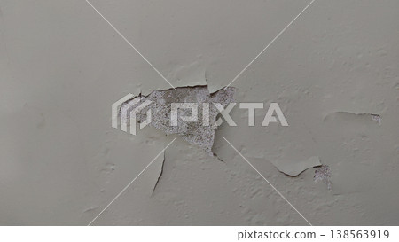 Damaged wall with peeling paint cracks and rough plaster surface showing decay 138563919