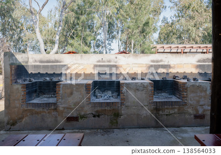 Outdoor barbecue grill station with brick fire pits in campsite park rustic cooking area travel and leisure concept Outdoor barbecue grill station with brick fire pits in campsite park rustic cooking area travel and leisure concept 138564033