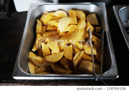 Slices fresh of ripe mango in an aluminum tray is dessert after breakfast in Thailand 138564106