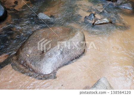 Canyon rocks and water stream with gravel 138564120