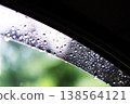 Fresh raindrops on the glass of car in rainy season 138564121