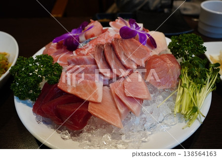 Fresh premium tuna sashimi platter served on crushed ice with garnish Fresh premium tuna sashimi platter served on crushed ice with garnish 138564163