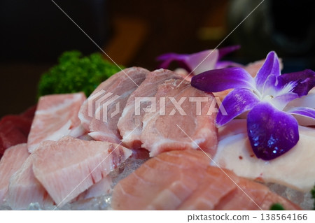Fresh premium maguro sashimi set decorated with edible flowers in a Japanese restaurant Fresh premium maguro sashimi set decorated with edible flowers in a Japanese restaurant 138564166