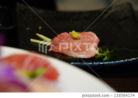 Close up of marbled bluefin tuna otoro sashimi garnished with radish sprouts 138564174