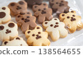 bag of cute, animal-shaped cookies with chocolate in the middle, set against a white background 138564655