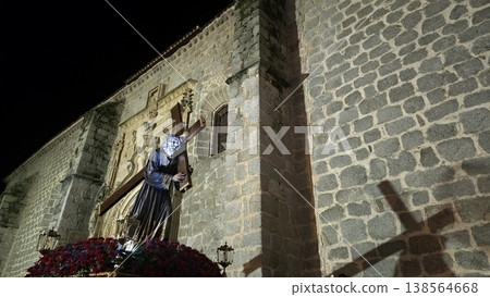 Outdoor religious statue of jesus carrying a cross by church facade at night for semana santa holy week procession poster and wallpaper Outdoor religious statue of jesus carrying a cross by church facade at night for semana santa holy week procession poster and wallpaper 138564668