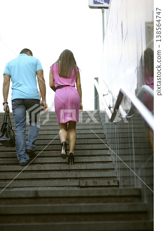 Couple walking up stairs at the underground pedestrian crossing in the city Couple walking up stairs at the underground pedestrian crossing in the city 138564747