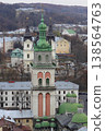 The Korniakt Tower and Dormition Church in Lviv with historic city architecture and hills, Ukraine 138564763