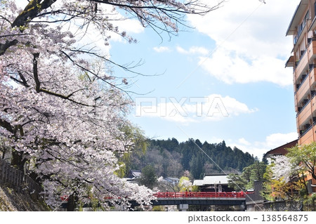 Takayama City, Gifu Prefecture, Japan - During the Takayama Spring Festival, cherry blossoms in full bloom and tourists crossing Nakabashi Bridge, beautiful blue sky, fresh greenery and the Miyagawa River Takayama City, Gifu Prefecture, Japan - During the Takayama Spring Festival, cherry blossoms in full bloom and tourists crossing Nakabashi Bridge, beautiful blue sky, fresh greenery and the Miyagawa River 138564875