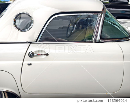 White classic car parked on street, gleaming chrome trim and polished hubcap reflecting sunny urban White classic car parked on street, gleaming chrome trim and polished hubcap reflecting sunny urban 138564914
