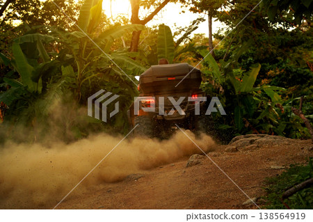 A man engages in extreme ATV riding on mountains in the evening A man engages in extreme ATV riding on mountains in the evening 138564919