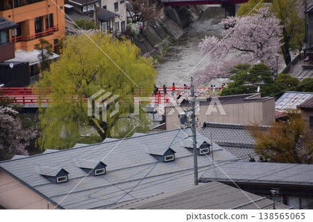 Takayama City, Gifu Prefecture, Japan: Beautiful townscape in the central area of Nakahashi. Cherry blossoms in full bloom, the Miyagawa River, and old and new houses. View from Shiroyama Park. 138565065