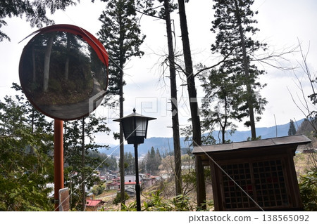 A view from the Higashiyama walking trail leading to Shiroyama Park in Takayama City, Gifu Prefecture, Japan, reflected in a convex mirror. A view from the Higashiyama walking trail leading to Shiroyama Park in Takayama City, Gifu Prefecture, Japan, reflected in a convex mirror. 138565092