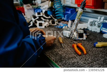 Electrician builder at work inspecting cabling connection of high voltage power electric line in industrial distribution fuseboard Electrician builder at work inspecting cabling connection of high voltage power electric line in industrial distribution fuseboard 138565226