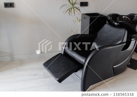 Detailed view of footrest with plush upholstery and sturdy hinge 138565338