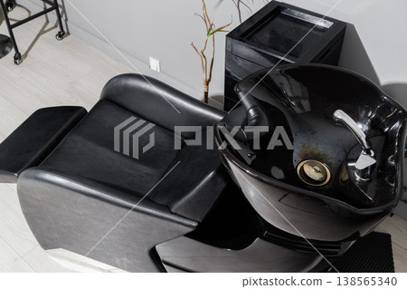 Closeup black shampoo basin and faucet, inspection detail Closeup black shampoo basin and faucet, inspection detail 138565340