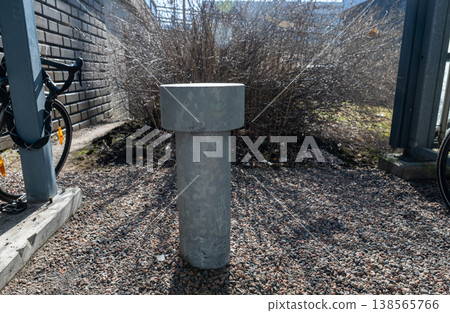Concrete bollard barrier in urban outdoor space with bicycle parking area safety infrastructure concept Concrete bollard barrier in urban outdoor space with bicycle parking area safety infrastructure concept 138565766