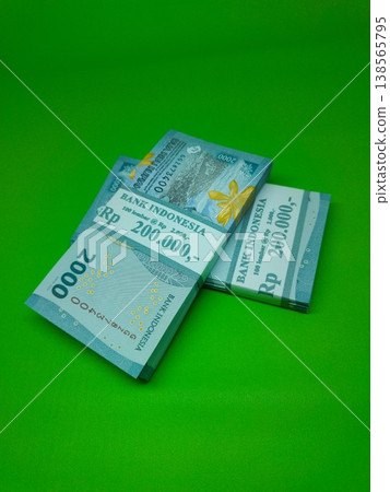 Green background holds neatly stacked banknotes. Stacks show denominations, clear and crisp. Ideal for financial, business, or economic imagery needs. No people, no animals, no plants visible here Green background holds neatly stacked banknotes. Stacks show denominations, clear and crisp. Ideal for financial, business, or economic imagery needs. No people, no animals, no plants visible here 138565795