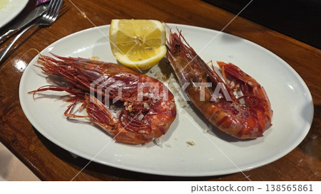 Spanish prawn tapas dish on a white plate with lemon and coarse salt for restaurant menu and food background photography. Carabinero, gamba carabinero, Aristaeopsis edwardsiana Spanish prawn tapas dish on a white plate with lemon and coarse salt for restaurant menu and food background photography. Carabinero, gamba carabinero, Aristaeopsis edwardsiana 138565861