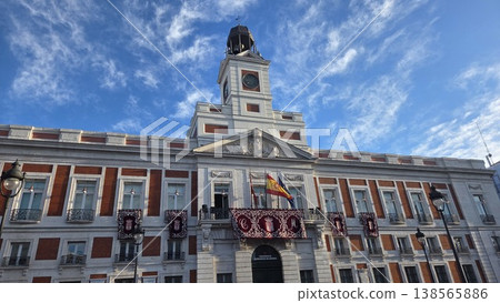 Historic Puerta del sol square building fachade with clock tower under blue sky for travel poster and city architecture background. Madrid, Spain 138565886