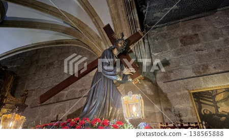 Religious statue of jesus carrying a cross inside church for semana santa holy week procession banner and poster design Religious statue of jesus carrying a cross inside church for semana santa holy week procession banner and poster design 138565888