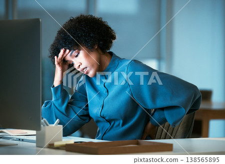 Back pain, night and business woman with burnout tired of overtime, deadline and work pressure and muscle strain. Corporate, headache and employee with stress injury working late in a company 138565895