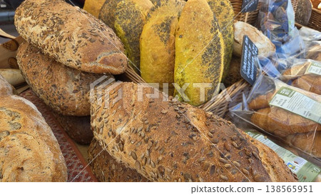 Assorted seeded artisan loaves including turmeric and multigrain bread at farmers market for bakery banner background Assorted seeded artisan loaves including turmeric and multigrain bread at farmers market for bakery banner background 138565951