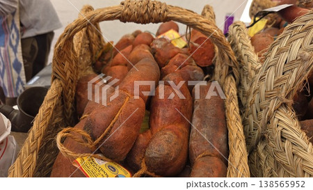 Rustic basket of cured sausages and chorizo at a spanish farmers market for food display and gourmet banner design 138565952