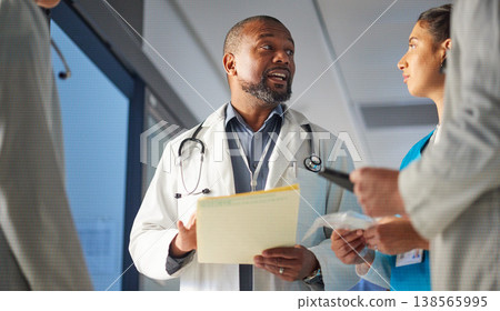 Black man, nurses or doctors talking in meeting for advice in healthcare discussion for documents. Mature surgeon, leadership or team working in collaboration for medical research in hospital clinic 138565995