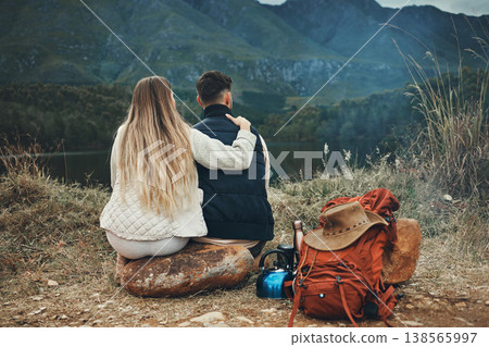 Couple, hug and relax at lake on camping, adventure or travel in mountain, nature or environment. People, hiking and bonding together in embrace for support or care on journey in forest and woods 138565997