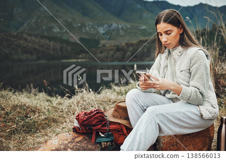 Nature, phone and young woman hiking on a mountain and network on social media or mobile app. Travel, technology and female person from Canada scroll on internet with cellphone in outdoor forest. Nature, phone and young woman hiking on a mountain and network on social media or mobile app. Travel, technology and female person from Canada scroll on internet with cellphone in outdoor forest. 138566013