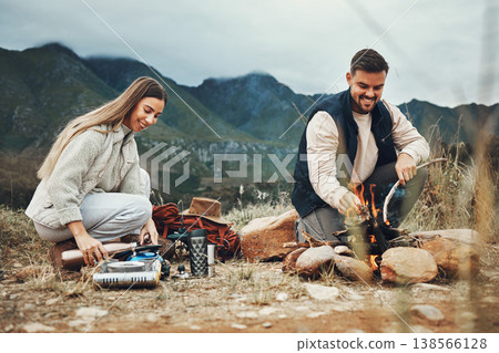 Couple, camping and fire in nature, mountains and outdoor for sustainable heating, vacation and prepare kettle. Happy man and woman in field with water, campfire or flames for cooking on holiday Couple, camping and fire in nature, mountains and outdoor for sustainable heating, vacation and prepare kettle. Happy man and woman in field with water, campfire or flames for cooking on holiday 138566128