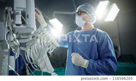 Healthcare, monitor and vital with a doctor in theater getting ready for surgery in a hospital operating room. Medical, technology and equipment with a surgeon in a clinic as a medicine professional Healthcare, monitor and vital with a doctor in theater getting ready for surgery in a hospital operating room. Medical, technology and equipment with a surgeon in a clinic as a medicine professional 138566205