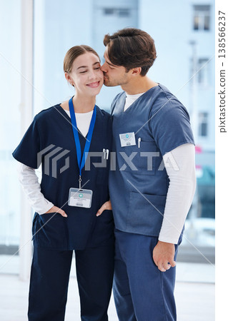 Couple, hospital and doctors kiss for love, happy relationship and work romance in clinic. Healthcare team, collaboration and man and woman embrace in medical service, support and medicare career 138566237