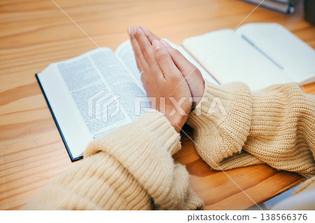 Hands, bible and praying at desk, religion and Christian worship in home at table. Closeup, holy book and woman in meditation for God, Jesus and Christ for faith in spiritual gospel, praise or hope Hands, bible and praying at desk, religion and Christian worship in home at table. Closeup, holy book and woman in meditation for God, Jesus and Christ for faith in spiritual gospel, praise or hope 138566376