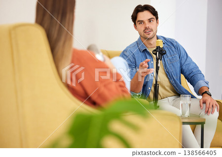 Man, woman and microphone for podcast, interview or question in conversation, speaking and lounge chair. Talk show, mic and people for web radio broadcast, live streaming and happy on social network Man, woman and microphone for podcast, interview or question in conversation, speaking and lounge chair. Talk show, mic and people for web radio broadcast, live streaming and happy on social network 138566405