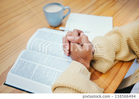 Hands, bible and praying at table, religion and Christian worship in home at desk. Closeup, holy book and woman in meditation for God, Jesus and Christ for faith in spiritual gospel, praise or hope Hands, bible and praying at table, religion and Christian worship in home at desk. Closeup, holy book and woman in meditation for God, Jesus and Christ for faith in spiritual gospel, praise or hope 138566494