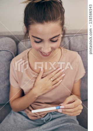 Pregnancy test, smile and woman on sofa in home, reading good news and check positive results. Pregnant, stick and happy mother in living room excited for success, future maternity and ivf fertility 138566543