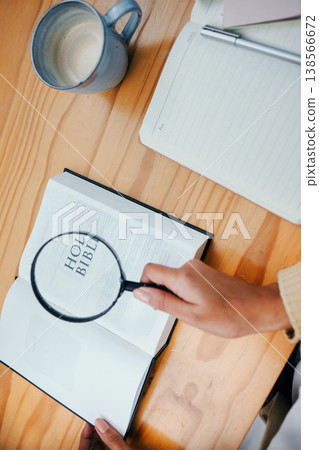 Bible, research and hands of person with magnifying glass to study religion, holy spirit and the gospel of God to worship. Information, spiritual and closeup of Christian learning faith and prayer 138566672