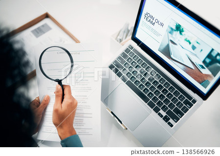 Magnifying glass, laptop and woman reading document in the office for company recruitment website. Research, technology and closeup of female designer with hiring paperwork and computer in workplace. Magnifying glass, laptop and woman reading document in the office for company recruitment website. Research, technology and closeup of female designer with hiring paperwork and computer in workplace. 138566926