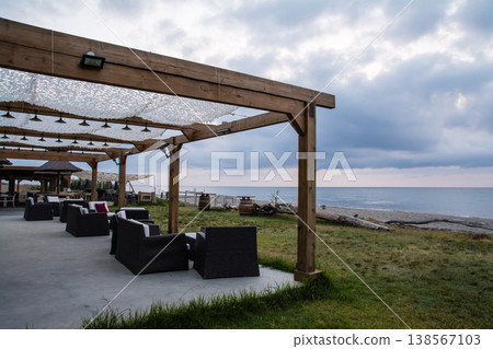 Chairs and tables lined up in front of a restaurant along the coast, on the French island of Corsica in the Mediterranean Sea. Chairs and tables lined up in front of a restaurant along the coast, on the French island of Corsica in the Mediterranean Sea. 138567103