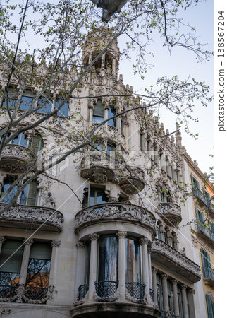 Ornate Art Nouveau building facade with intricate balconies and sculptural details in Barcelona city architecture Ornate Art Nouveau building facade with intricate balconies and sculptural details in Barcelona city architecture 138567204