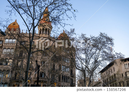 historic european architecture with ornate facade tower and trees in urban street under clear sky historic european architecture with ornate facade tower and trees in urban street under clear sky 138567206