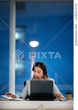 Business woman, notebook and call center communication, planning and night advice, support or writing a reminder. FInancial advisor or virtual agent speaking on laptop and notes for help with loan Business woman, notebook and call center communication, planning and night advice, support or writing a reminder. FInancial advisor or virtual agent speaking on laptop and notes for help with loan 138567278