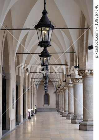 Historic European arcade with ornate lanterns and vaulted ceilings, showcasing classical architecture and a sense of timeless elegance in a public thoroughfare 138567546