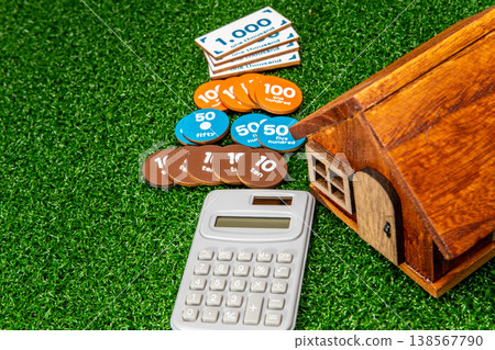 A model of a house and an image of money A model of a house and an image of money 138567790