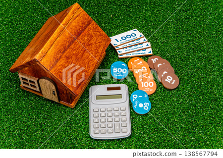 A model of a house and an image of money A model of a house and an image of money 138567794