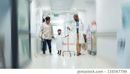Medical, pediatrician and a doctor walking with a black family in a hospital corridor for diagnosis. Healthcare, communication and consulting with a medicine professional talking to a boy patient Medical, pediatrician and a doctor walking with a black family in a hospital corridor for diagnosis. Healthcare, communication and consulting with a medicine professional talking to a boy patient 138567799