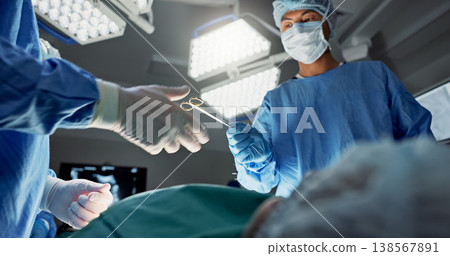 Doctors, team and scissors in theater for surgery, healthcare or medical support and operation room at hospital. Surgeon, medicine and teamwork or collaboration with tools for cardiology or emergency Doctors, team and scissors in theater for surgery, healthcare or medical support and operation room at hospital. Surgeon, medicine and teamwork or collaboration with tools for cardiology or emergency 138567891